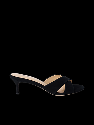 A black, open-toe mule heel sandal with a low kitten heel and wide crisscross suede straps, shown in a side profile view against a plain black background.