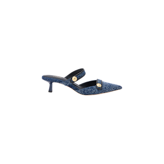 The Gilliane Denim Mule is a blue slingback pointed-toe shoe with embossed dome buttons, featuring textured denim-like fabric, a mid-height stiletto heel, and memory foam cushioning for enhanced comfort.