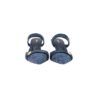 Introducing the Gilliane Denim Mule: open-toe mule sandals with ankle straps and embossed dome buttons, featuring a comfortable memory foam cushion, displayed on a plain white background.