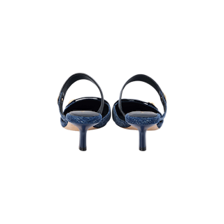 A pair of Gilliane Denim Mule slingback high-heeled shoes, shown from the back against a white background, featuring memory foam cushioning for added comfort and supportive ankle straps.
