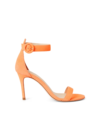 The Gisele Sandal is crafted from orange suede and features an ankle strap with a buckle, an open toe, and a thin minimalist heel. The ankle-strap sandal is shown in profile on a white background.