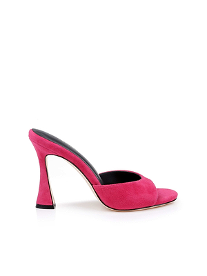 The Avery Suede Open-Toe Mule in hot pink features a wide strap and a flared, curved heel, shown against a white background.