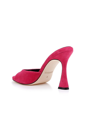 The Avery Suede Open-Toe Mule in hot pink features a single open toe, curved flared heel, and is shown from the back on a white background. 