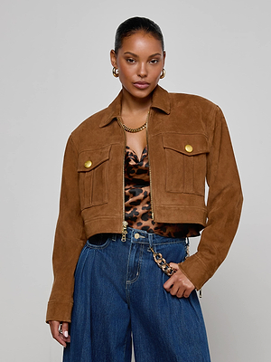 A woman wears the Micah Oversized Suede Jacket with gold buttons, a leopard print top, blue wide-leg jeans with a chain belt, gold earrings, and a gold necklace as she stands against a plain light background.