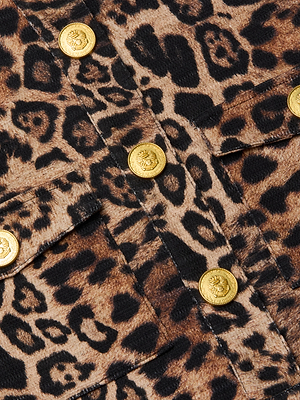 Close-up of the Nyx Cropped Jacket, featuring brown and black tweed leopard print and a row of gold embossed decorative buttons.