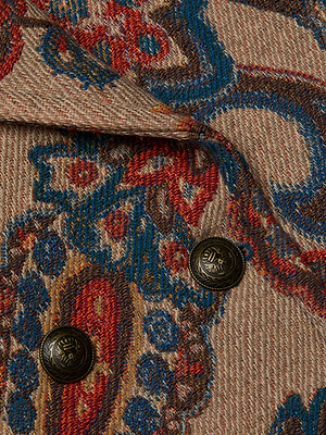 Close-up of the Kelsey Peacoat by L'AGENCE, showcasing textured paisley jacquard fabric in blue, red, and brown with two engraved brass buttons—a standout piece for any wardrobe.