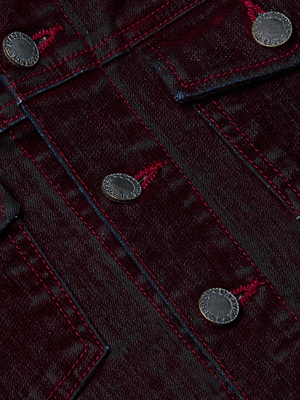Close-up of the Maven Flocked Jean Jacket by L'AGENCE, crafted with velvet-finish denim, red stitching, silver metal buttons, and highlighted detailed seams and pocket flaps for a stylish look.