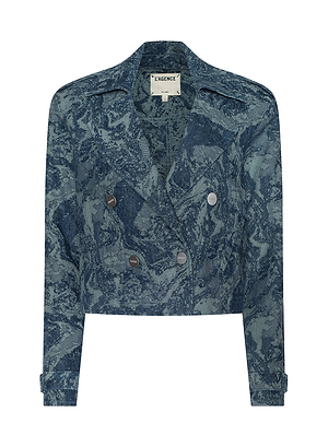 The Maddox Jean Trench Coat is a cropped, double-breasted denim jacket with a blue marbled wash, silver buttons, long sleeves, and a notched collar—a statement piece inspired by New York Fashion Week style. L’AGENCE label inside.