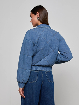 A woman with straight brown hair wears the L'AGENCE Ryah Bomber Jacket with matching wide-leg jeans, facing away from the camera against a plain light background.