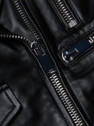 Close-up of shiny silver zippers on the Blakely Leather Biker Jacket, crafted from black lambskin leather, highlighting the texture and detailed stitching.