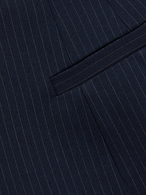 Close-up of dark fabric with thin, light pinstripes and a pocket, likely part of the Therese Blazer.