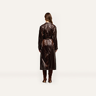 Back view of a person wearing an oversized, double-breasted dark brown Brinley Nylon Trench Coat and knee-high heeled boots.