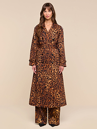 A woman stands facing forward, wearing the Brinley Oversized Trench Coat styled with matching wide-leg trousers. The background is plain white.