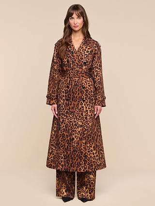 A woman stands facing forward wearing the Brinley Oversized Trench Coat layered over matching wide-leg pants against a plain beige background.