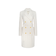 The Cooper Tweed Trench Coat, shown against a plain white background, is a white, knee-length, double-breasted coat crafted from textured tweed with gold buttons and a matching fabric belt that exudes downtown sensibility.