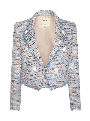 The Marv Tweed Blazer by L’AGENCE is a cropped, boxy fit jacket with a blue, white, and brown pattern, notched collar, statement double-breasted buttons, and fringe trim along the hem and edges.