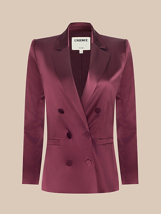 The Sena Silk Blazer, shown in a vibrant merlot red with a lustrous finish, features matching buttons, a double-breasted design, and a notched collar—presented against a plain beige background.
