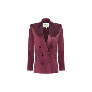 The Sena Silk Blazer is a merlot red satin double-breasted blazer featuring a notched lapel, long sleeves, and two rows of dark buttons, displayed on a plain white background. This elegant piece effortlessly combines classic tailoring with modern sophistication.