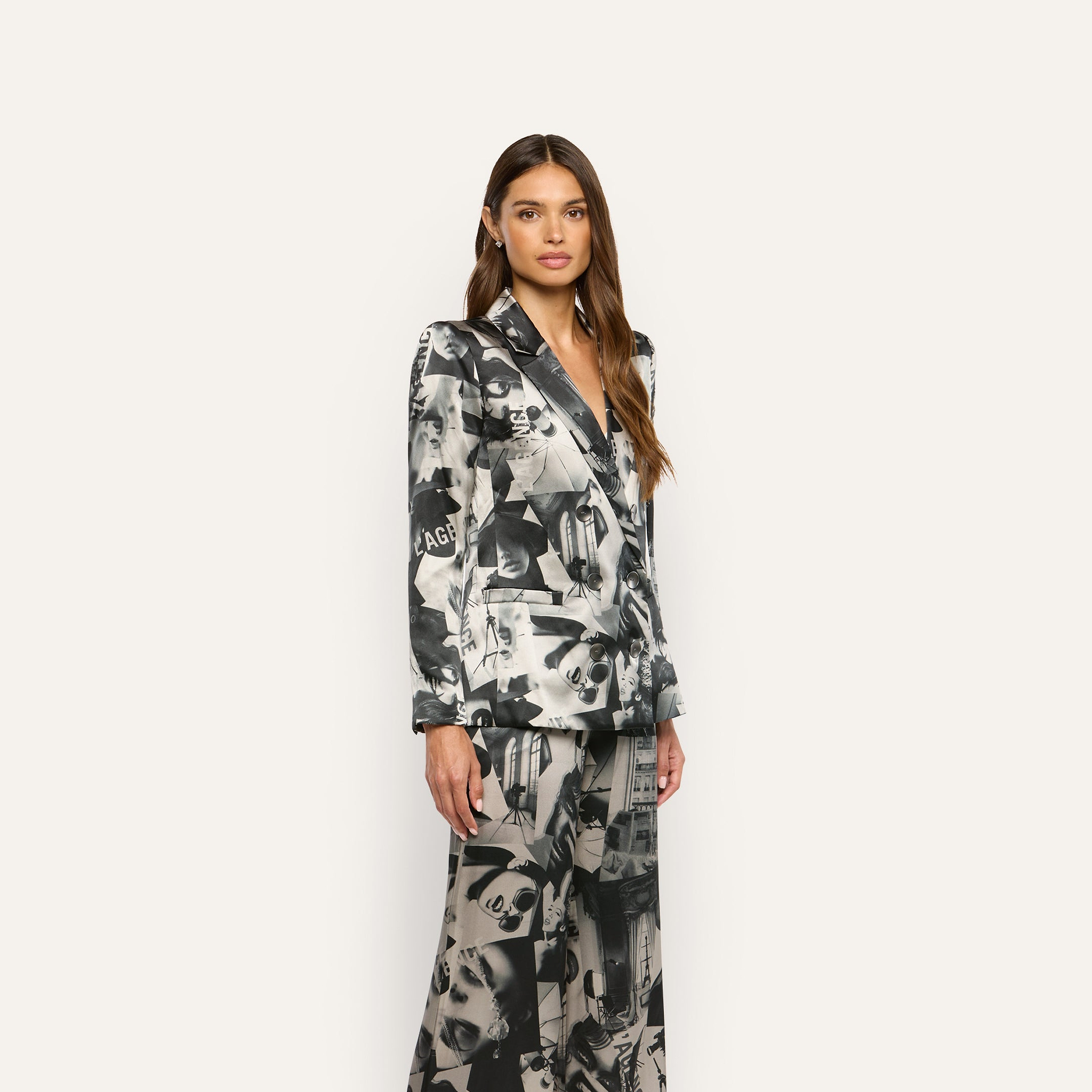 A model wears a Sena Silk Blazer and wide-leg trousers featuring a black-and-white statement print.
