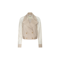 The Novelle Lace Trench is a beige cropped double-breasted trench coat with floral lace sleeves and a wide lapel, displayed against a plain white background. This lightweight layer adds elegance to any outfit.