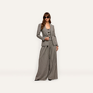 A model wearing a Blanche Blazer, button-front vest, and wide-leg trousers, styled with dark sunglasses.