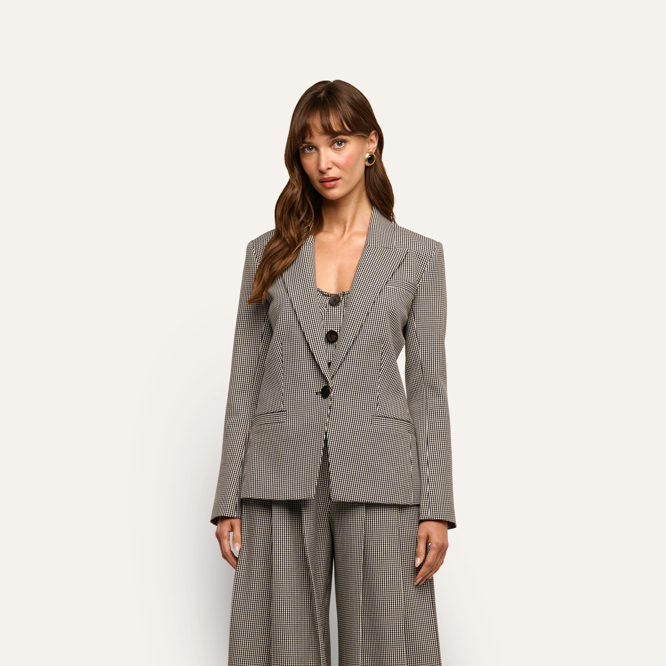 A woman wearing a Blanche Blazer over a matching button-front vest and wide-leg trousers.