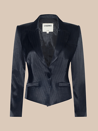 The Misa Blazer is a dark navy single-breasted blazer with a black pinstripe pattern, featuring a single button closure, peaked lapels, and two front pockets, displayed against a beige background.