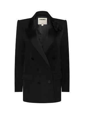 The Cambrie Oversized Blazer: a black double-breasted design with satin lapels, structured shoulders, front pockets, and a fabric flower detail—standout from NYFW Fall 2026—shown on a plain white background.