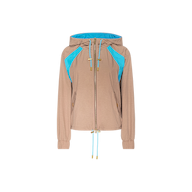 The Lark Windbreaker by L’AGENCE is a light brown jacket showcasing retro color blocking with vivid blue accents on the shoulders and inside the hood. It features a front zipper, two side pockets, elastic cuffs, and adjustable drawstrings at both the hem and hood.