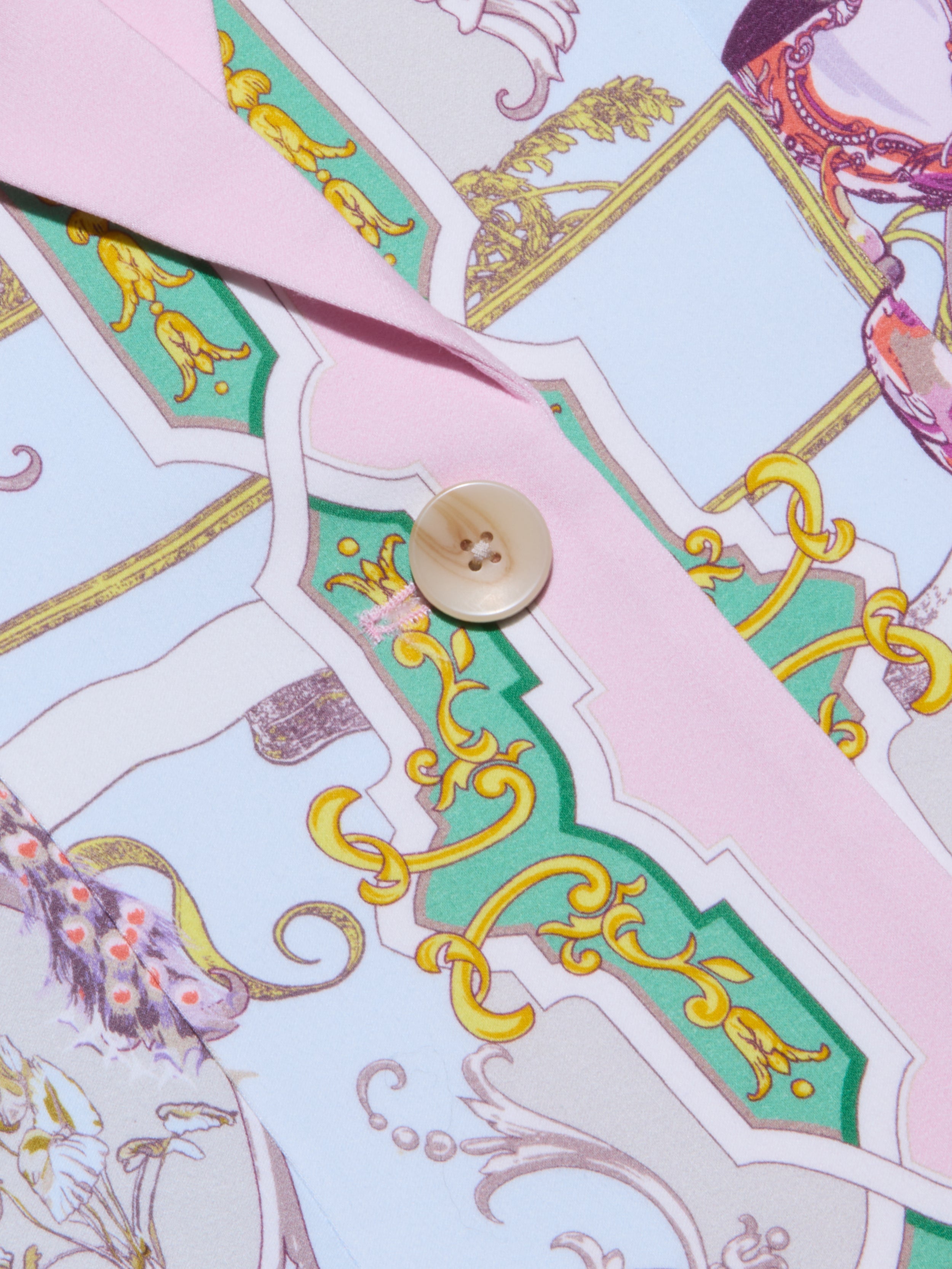 Close-up of the Gweny Blazer in satin back crepe, showcasing a relaxed fit and vibrant baroque-inspired gold, green, and pink pattern. Finished with a single beige button on pink trim for an elegant touch.