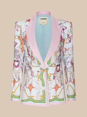 The Gweny Blazer is a women’s tailored baroque toile blazer in satin back crepe, featuring a pastel pink collar, ornate gold swirls and scrolls, relaxed fit, and finished with the LAGENCE label inside.