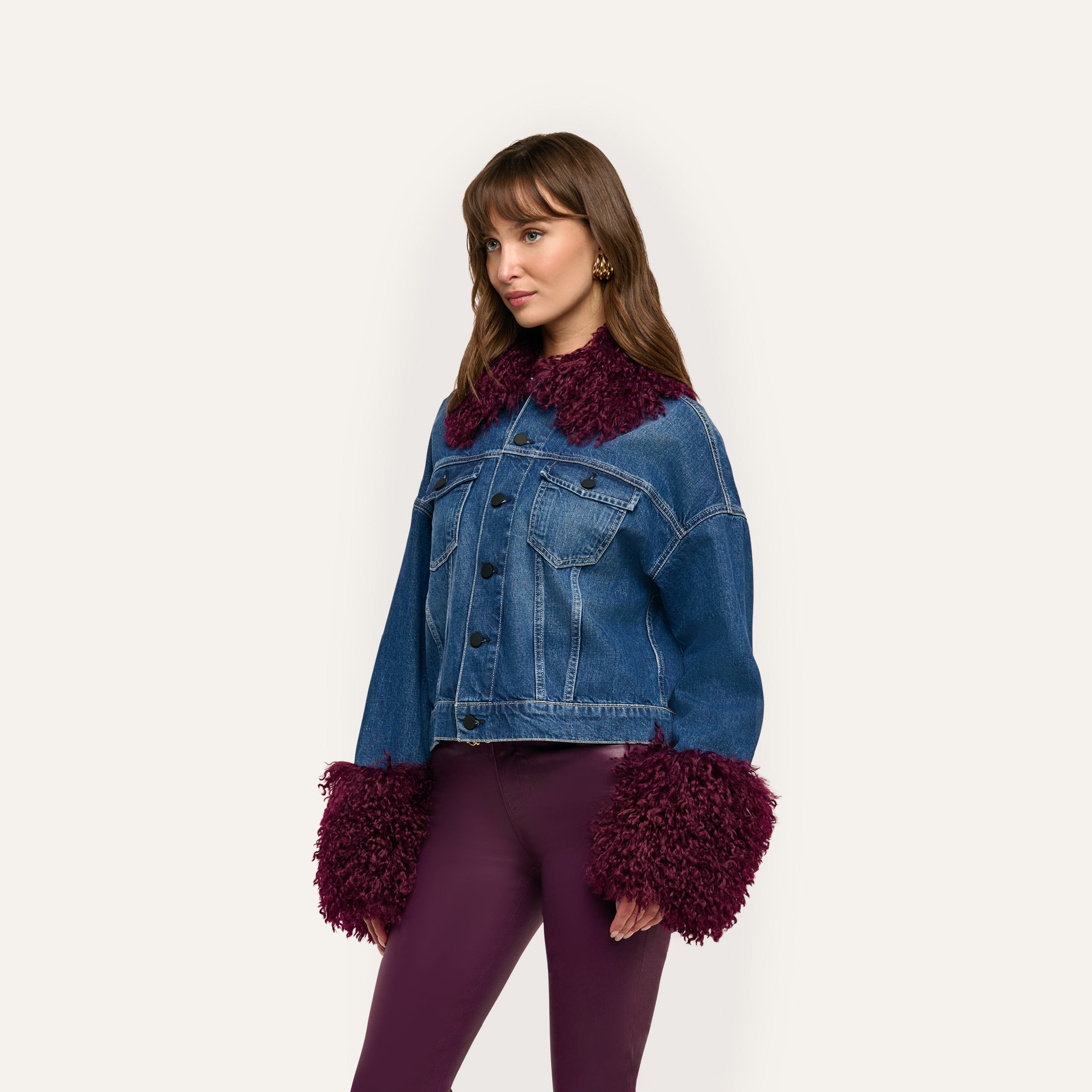 Bronson Jean Jacket in cropped blue denim with a dark red faux fur trim collar and oversized fuzzy cuffs.