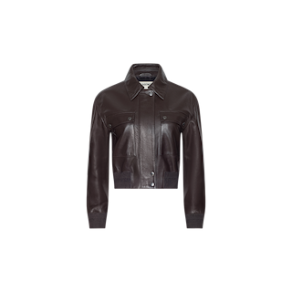 The Clotilde Leather Jacket, crafted from dark brown fine-grain leather, features a collar, button front, long sleeves, two chest pockets with flaps, and ribbed cuffs and hem for a touch of luxury layering. This cropped bomber jacket is shown against a plain white background.