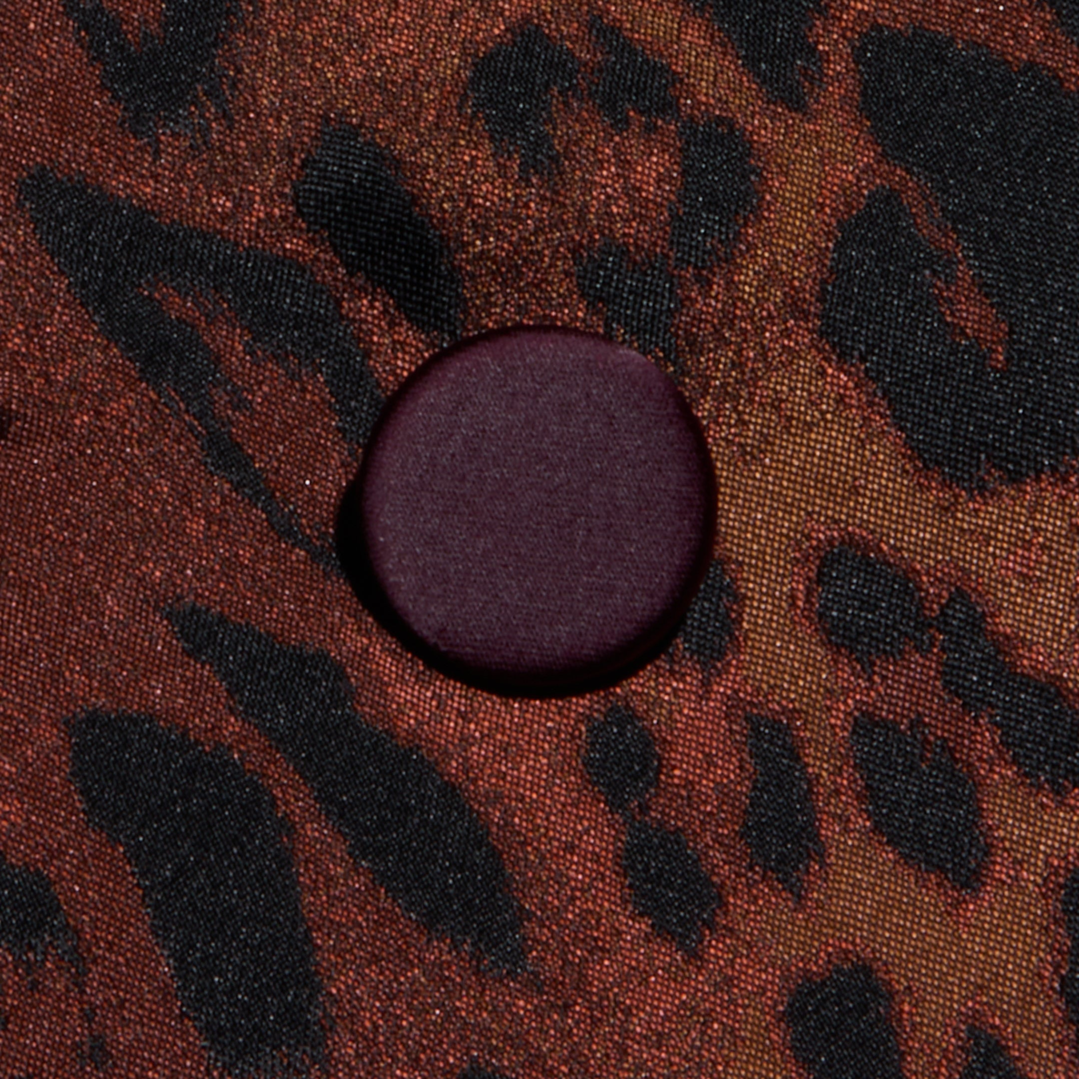 A round, dark purple button is sewn onto the Kyomi Double-Breasted Blazer, featuring a black and brown leopard jacquard pattern.