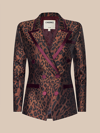 The Kyomi Double-Breasted Blazer by LAGENCE features a bold brown and black leopard jacquard print, complemented by burgundy trim, satin lapels, and matching buttons. This striking blazer is showcased on a beige background.