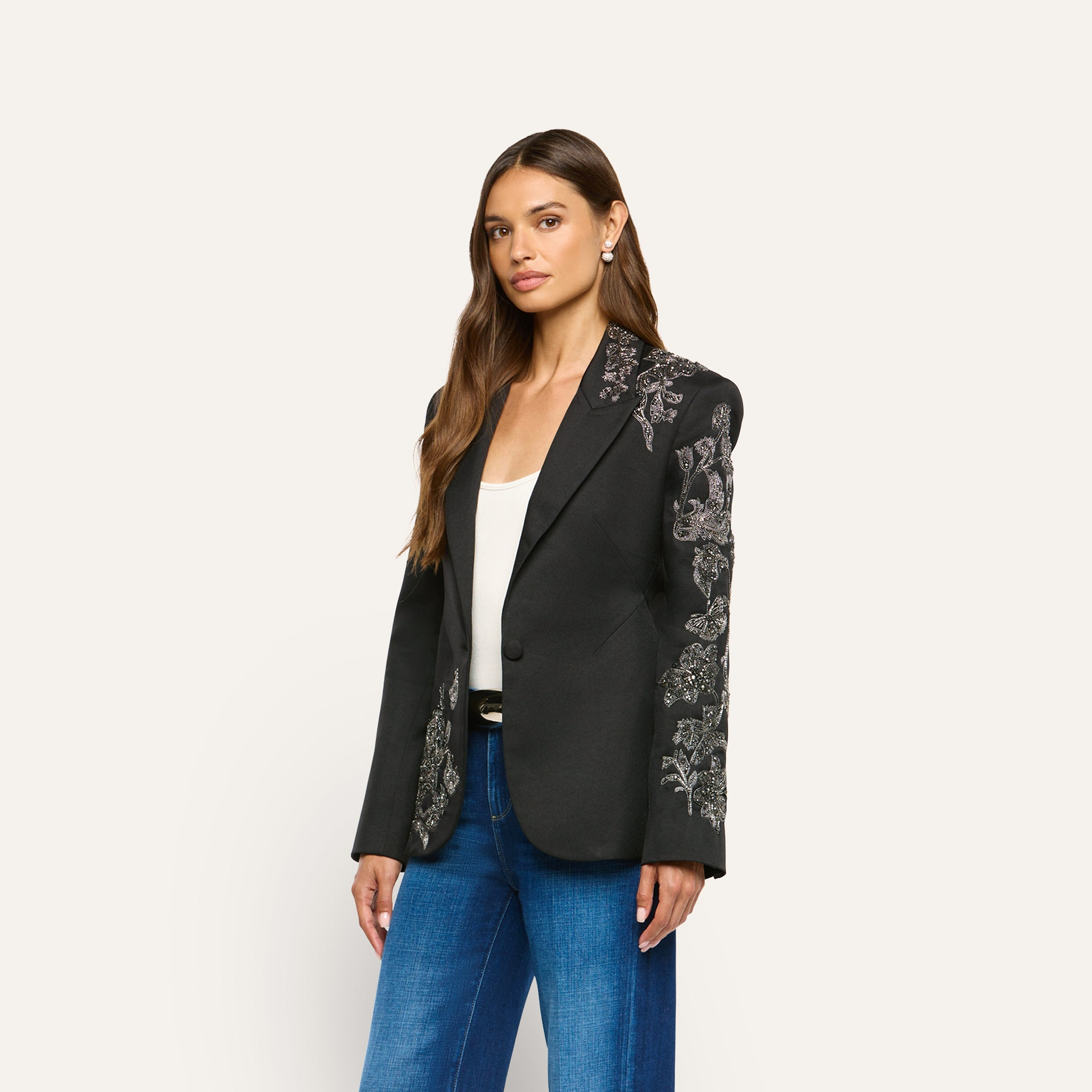 The Clementine Embellished Blazer is a black twill blazer featuring ornate, silver-toned floral embroidery on the shoulders and sleeves.
