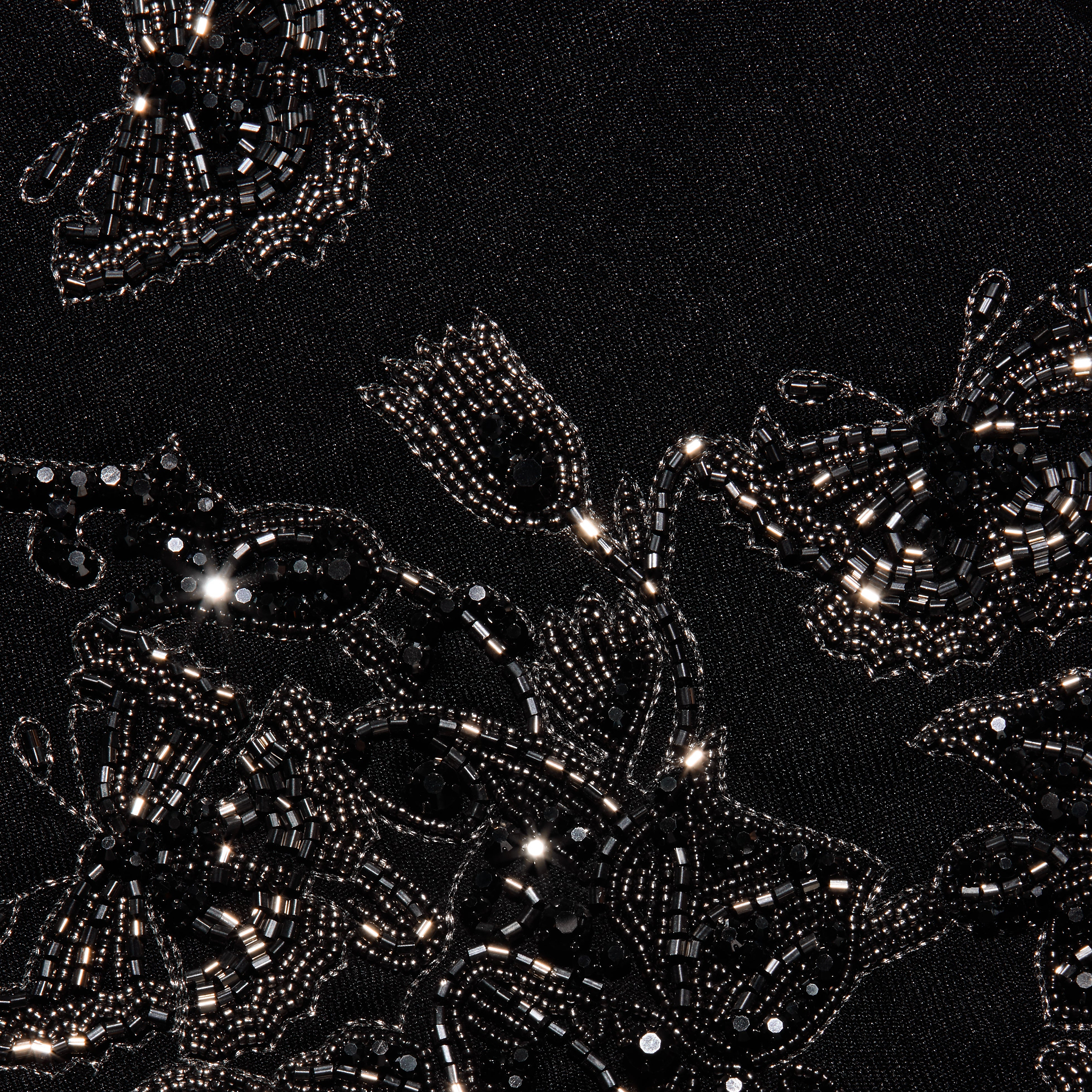 Clementine Embellished Blazer in black twill, detailed with intricate floral embroidery made of shiny black beads and sequins.