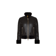The Glacia Shearling Jacket is a cropped black lambskin leather jacket featuring a high collar, gold zippers, two front pockets, and fur trim at the collar, cuffs, and hem. It is displayed on a plain white background.