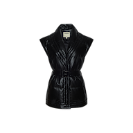The Ignis Puffer Vest is a black sleeveless quilted vegan leather vest featuring a shawl collar and a matching belted waist, showcased on a plain white background. This chic piece serves perfectly as transitional outerwear.