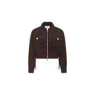 The Kade Windbreaker is a cropped nylon jacket in dark brown, featuring a front zipper, two large chest pockets each adorned with a yellow button, long sleeves, and a collared neckline, displayed against a white background.