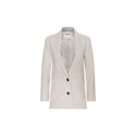 The Amelie Blazer is a light gray women’s fitted blazer crafted in herringbone tweed, featuring two black buttons, two front pockets, and a notched lapel. Displayed on a plain white background, this style draws inspiration from New York Fashion Week.