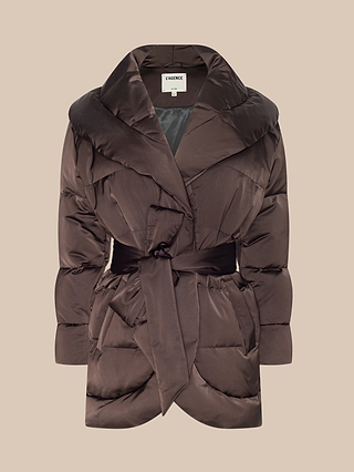 The Glacier Shawl Puffer Jacket, shown on a plain beige background, features a brown quilted, water-repellent design with a wide collar, long sleeves, and a matching fabric belt tied at the waist.