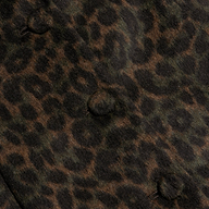 Close-up of the Laney Coat’s brown and black leopard print fabric, featuring three fabric-covered buttons. The pattern showcases dark rosette spots on a muted brown background—perfect for making a statement.