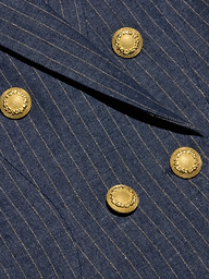 Close-up of the Solar Pinstriped Blazer in blue, showcasing its pinstripe fabric, folded lapel, and four decorative gold buttons—suggesting a tailored double-breasted design.