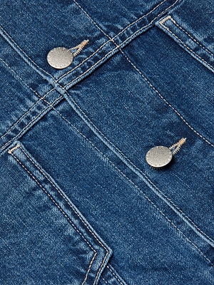Close-up of all-cotton denim fabric with detailed stitching, two silver metal buttons, and seams on the Silas Cape Jacket.