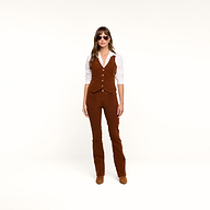 A woman stands facing forward on a plain white background, arms at her sides, wearing sunglasses, a white shirt, the Yelena Vest, and matching casual corduroy brown pants.