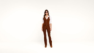 A woman stands against a plain white background, wearing sunglasses, a white shirt, and a brown vest with matching brown flared pants and shoes.