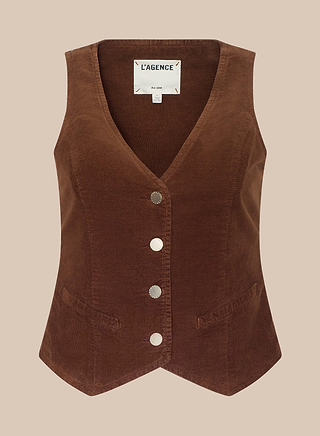 Introducing the Yelena Vest: a brown tailored piece made from stretch corduroy, designed with a V-neckline, four silver buttons down the front, two petite front pockets, and an interior collar label reading LAGENCE.