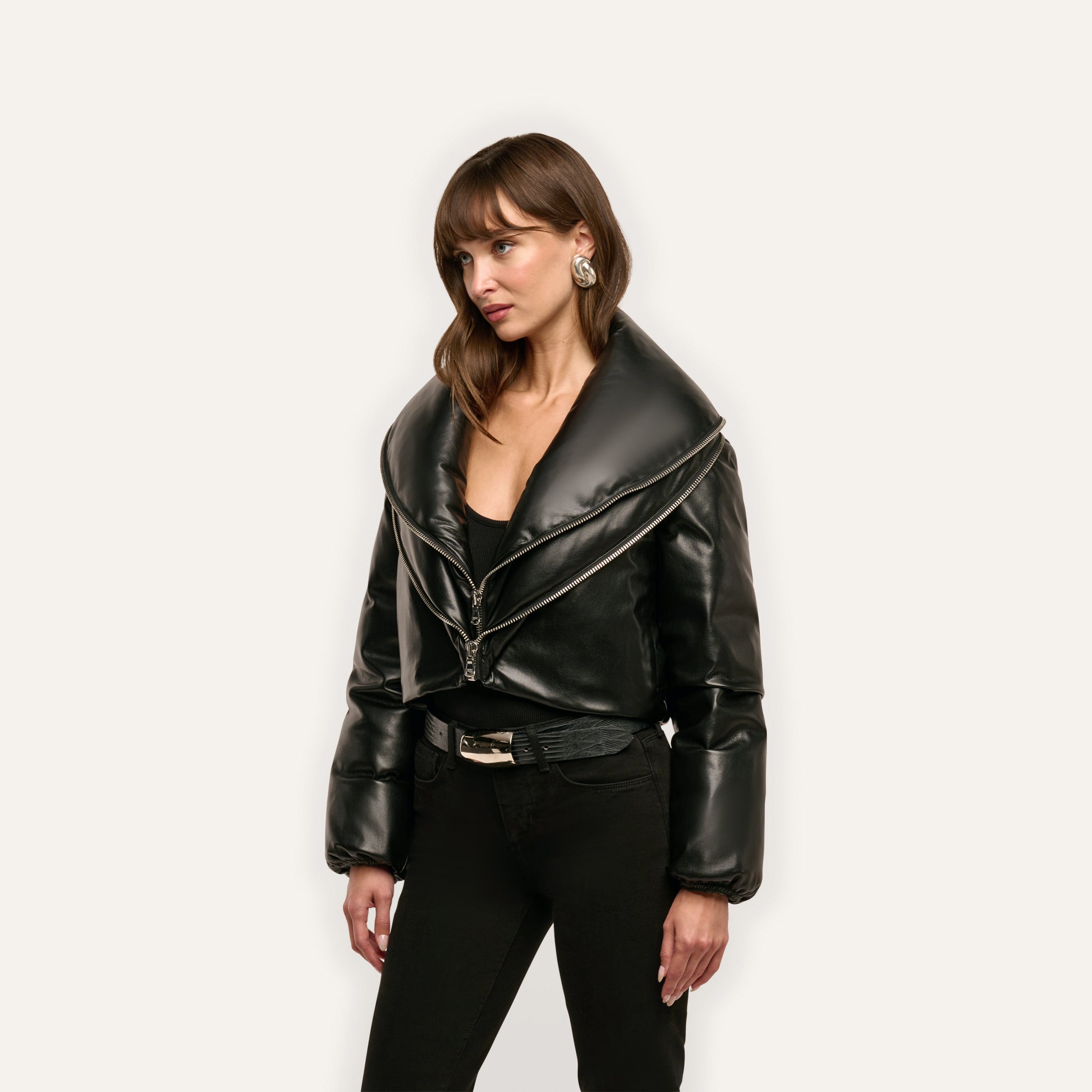 A black cropped Vail Puffer jacket featuring an oversized collar and an asymmetrical zipper.