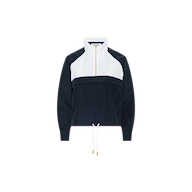 The Vex Cropped Windbreaker is a black and white long-sleeve activewear jacket featuring a front zip, high collar, and drawstring hem, shown against a plain white background. This windbreaker combines style with functionality.